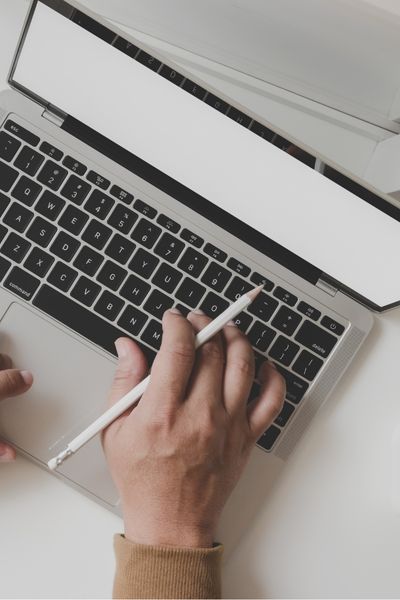 person typing on computer using property management software